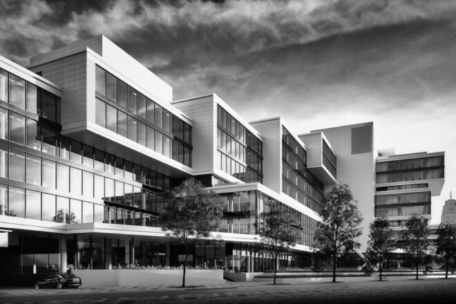 a black and white photo of a tiered building with windows covering the facade and a cement courtyard in front