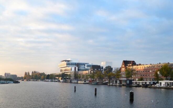 a riverfront with buildings in the background