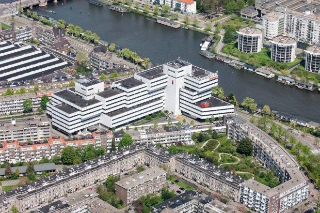 a bird's-eye view of the old Rivierstaete building, showing the city, trees and river
