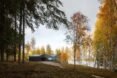 dark home with angular roof on natural landscape