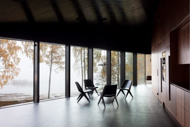 a dining set in a large room with wall of windows