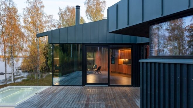 a wooden deck surrounded by glass doors