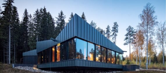 dark home with angular roof and several vertical windows