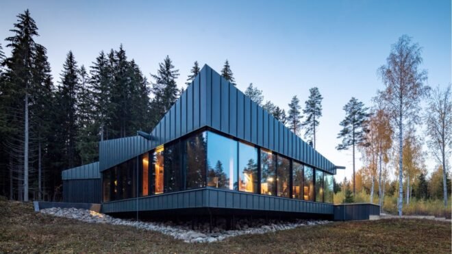 dark home with angular roof and several vertical windows