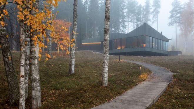 a curved walkway leading up to a dark home