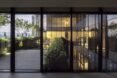 glass walls opening to wood patio