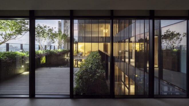 glass walls opening to wood patio
