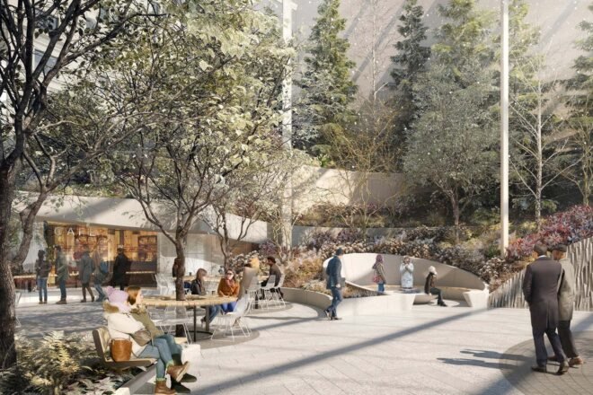 a tree-filled room with a vafe and sitting areas where people are lounging