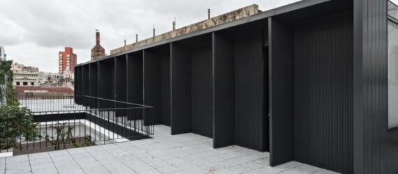 extended black structure with outdoor space