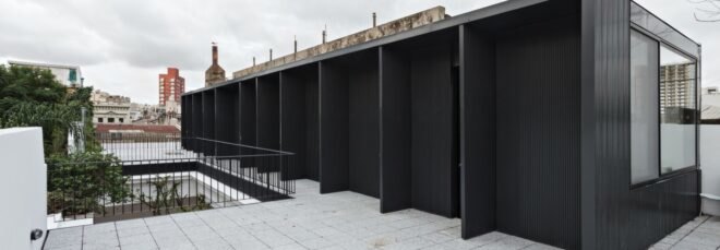 extended black structure with outdoor space