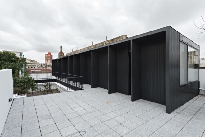extended black structure with outdoor space