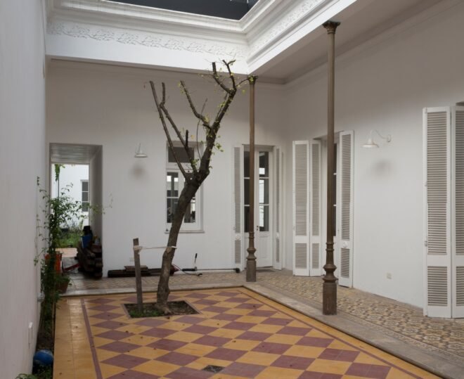 indoor courtyard with tree growing out of the tiled floor