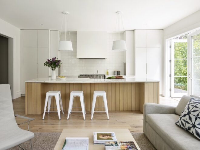 kitchen with wood island and white cabinets