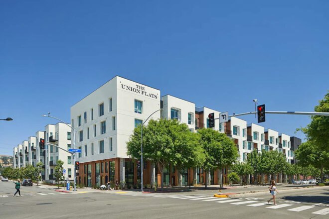 a streetview of The Union Flats housing, with trees and street in front of it