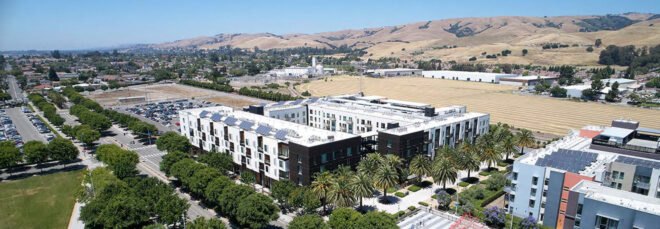 a view of the entire Union Flats housing community, surrounded by green trees and mountains in the background
