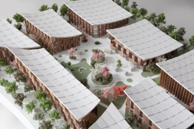 model of wood buildings around a central courtyard and garden