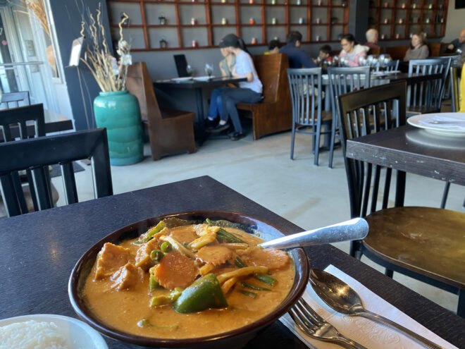 interior of a restaurant with a bowl of curry on the table