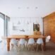 wood dining table with white chairs near white kitchen