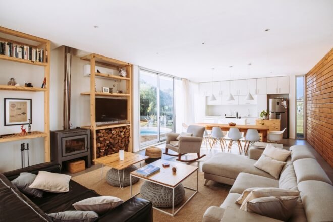 beige sofa and leather sofa around a wood-burning stove