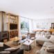 beige sofa and leather sofa around a wood-burning stove