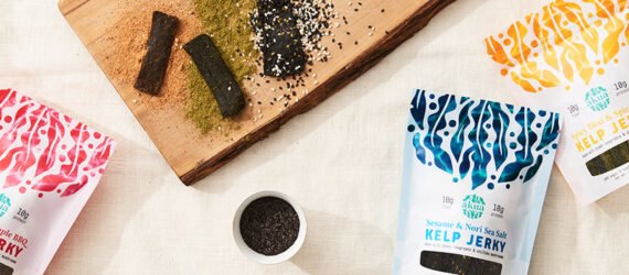 packages of kelp jerky near a cutting board