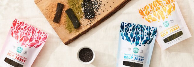 packages of kelp jerky near a cutting board