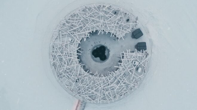 aerial shot of nestlike building with pool in the middile