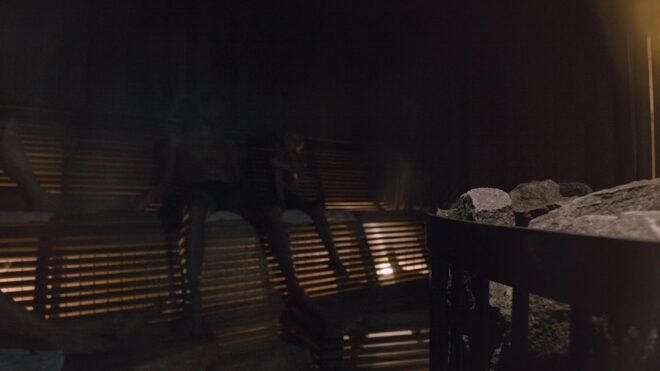 people sitting inside a sauna