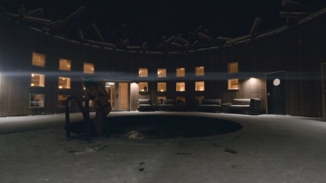 woman getting out of pool at night