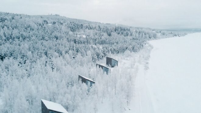 several cabins in a snow-covered forest