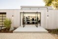 living room with glass walls open to outdoor terrace