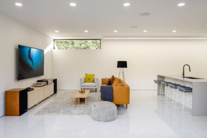 yellow couch in white living area