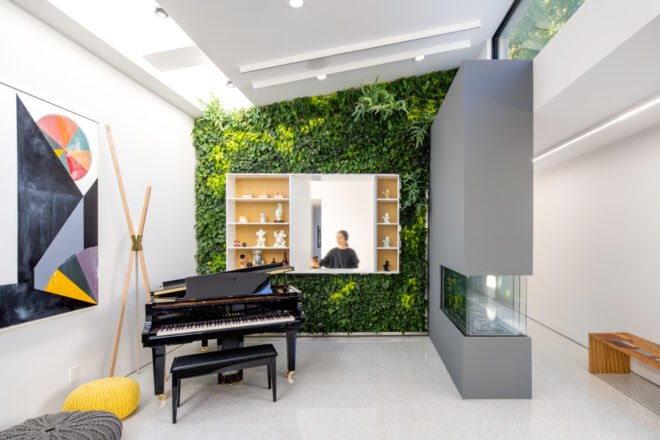 piano in front of a plant-covered wall