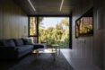 gray sofa beside large window with views of trees