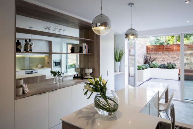 bright kitchen with white cabinets and white counters