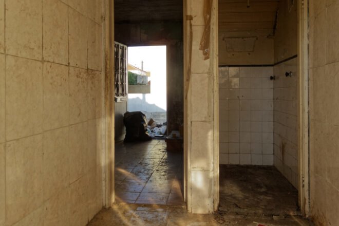 before image of old home with cracked tile walls