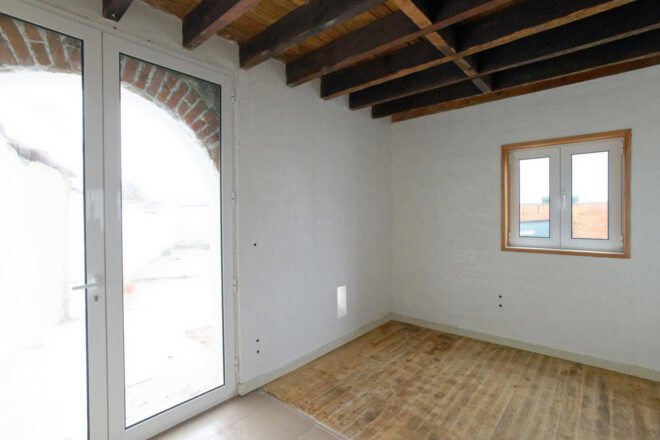 white room with glass door leading to outdoors