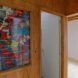 wood wall with glass panel revealing cloth insulation