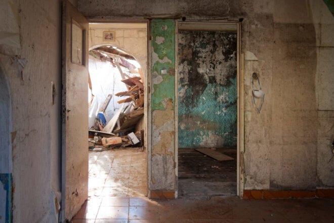 before image of old home with peeling green wallpaper