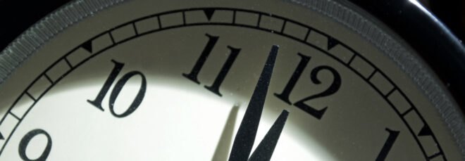 hands on a clock nearing midnight