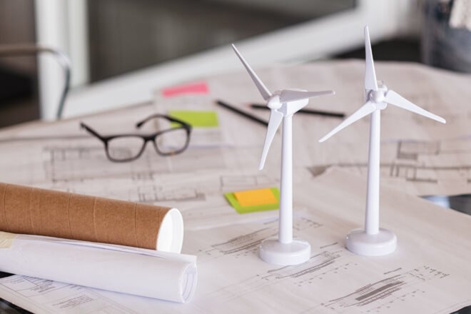 small wind turbine models and planning papers on a desk