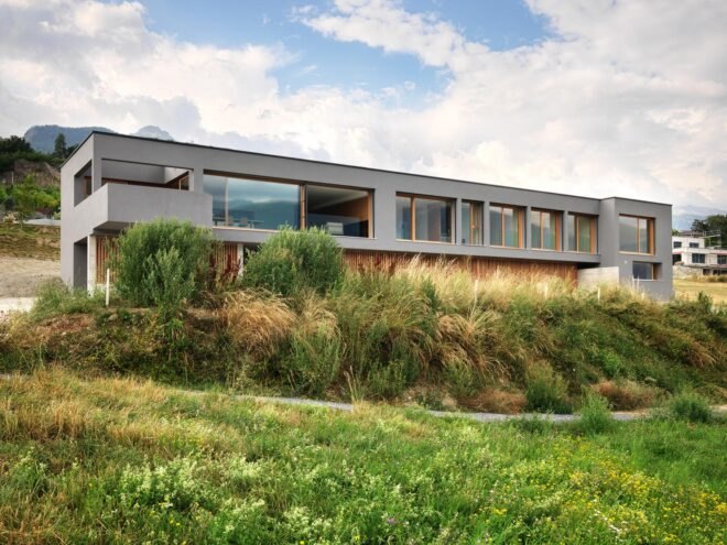 long gray home with several large windows