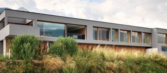 long gray home with several large windows