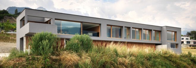 long gray home with several large windows