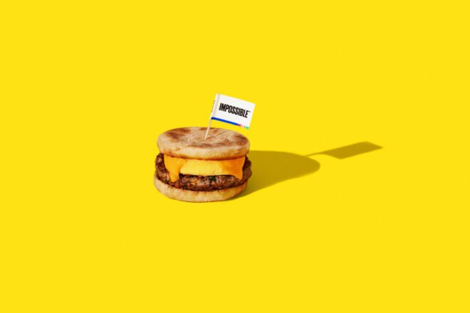 breakfast sandwich with plant-based sausage on yellow background