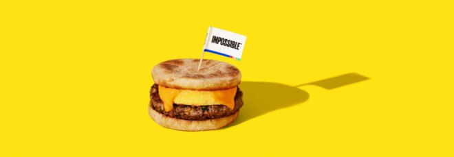 breakfast sandwich with plant-based sausage on yellow background