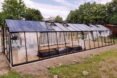 long narrow greenhouse with solar panels