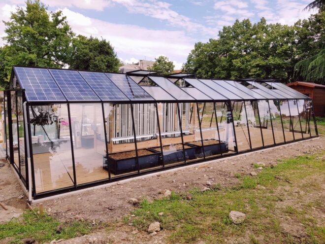 long narrow greenhouse with solar panels