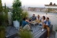 friends gathered at a table beside a vertical garden