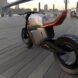 angled view from back of gray and orange hybrid motorcycle